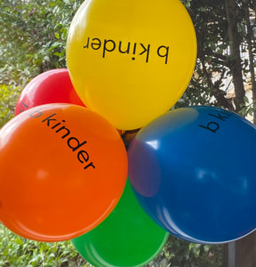 b kinder balloons in yellow, orange, blue, green, red with text 'b kinder' on them